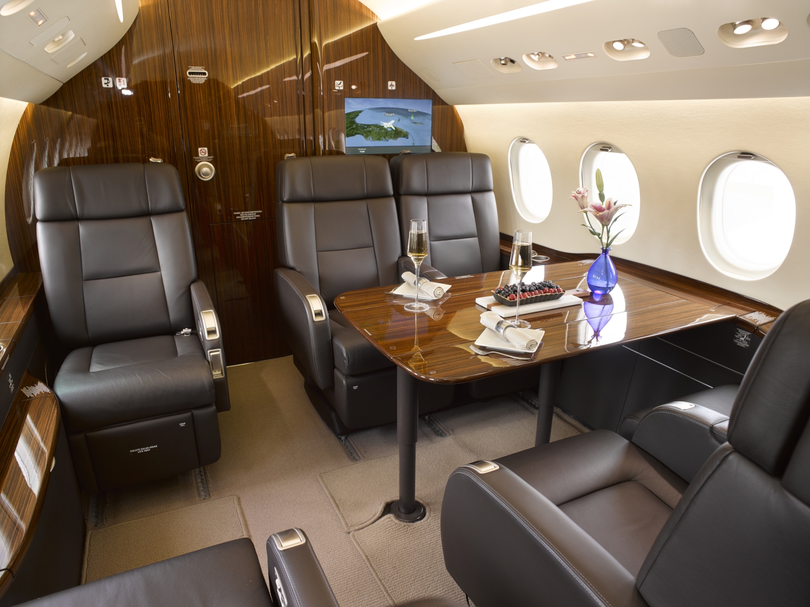 Private jet worked on by crew member and client walking out of aircraft
